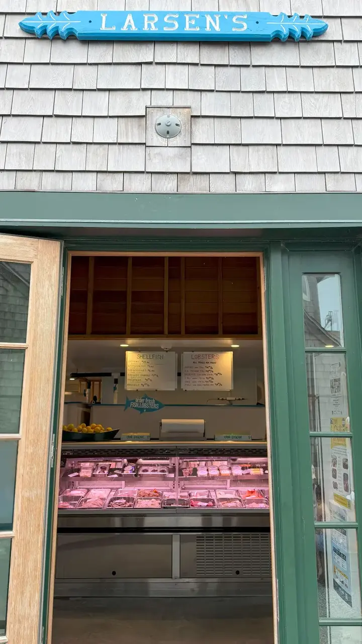 The blue Larsen's sign above the open service window and fish case in Menemsha