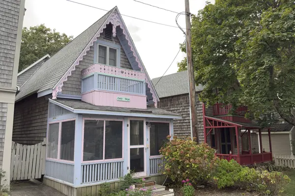 Lazy Dayz on Montgomery Square, pink scrollwork and a screened porch