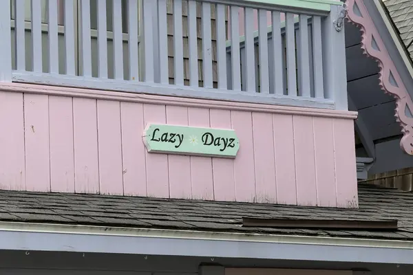 The Lazy Dayz name board, pink, green and lavender