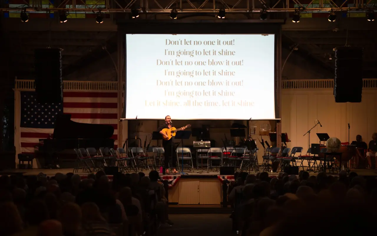 Band on stage and song lyrics on a screen inside the Tabernacle in Oak Bluffs