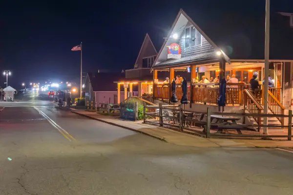 Lookout Tavern lit up over Seaview Avenue at night.