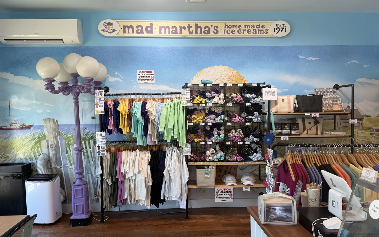 Merchandise wall inside a Mad Martha's ice cream shop with a beach mural