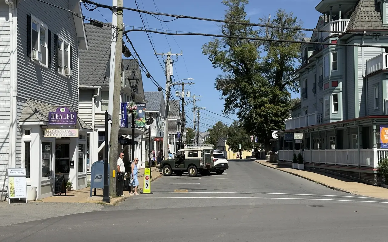 Main Street in Vineyard Haven in September: La Choza Burritos and a spa on the left, the Mansion House porches on the right, a Land Rover at the crosswalk