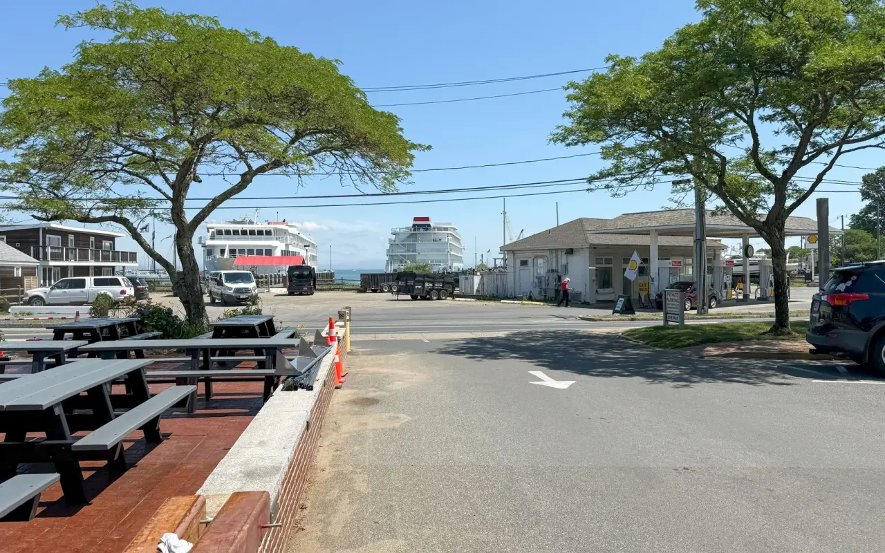 A Steamship Authority ferry at the Vineyard Haven terminal seen from Beach Road with picnic tables in front