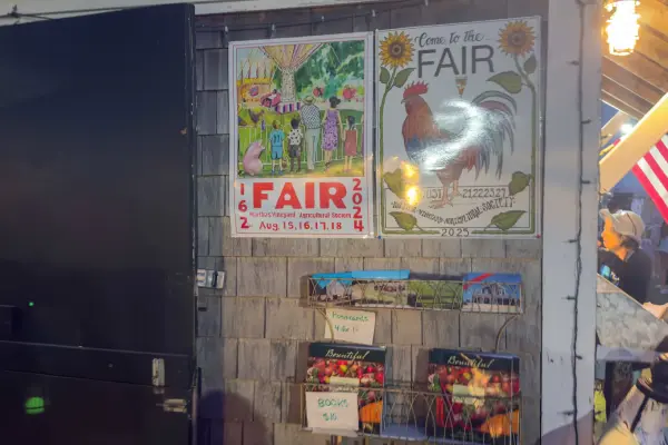 Posters from fairs past by the Hall, with postcards for sale below