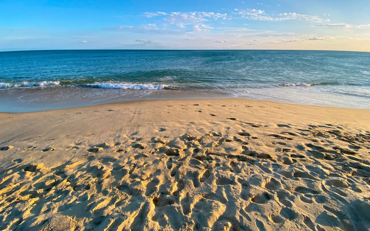 Wet sand and small waves on an empty stretch of South Beach