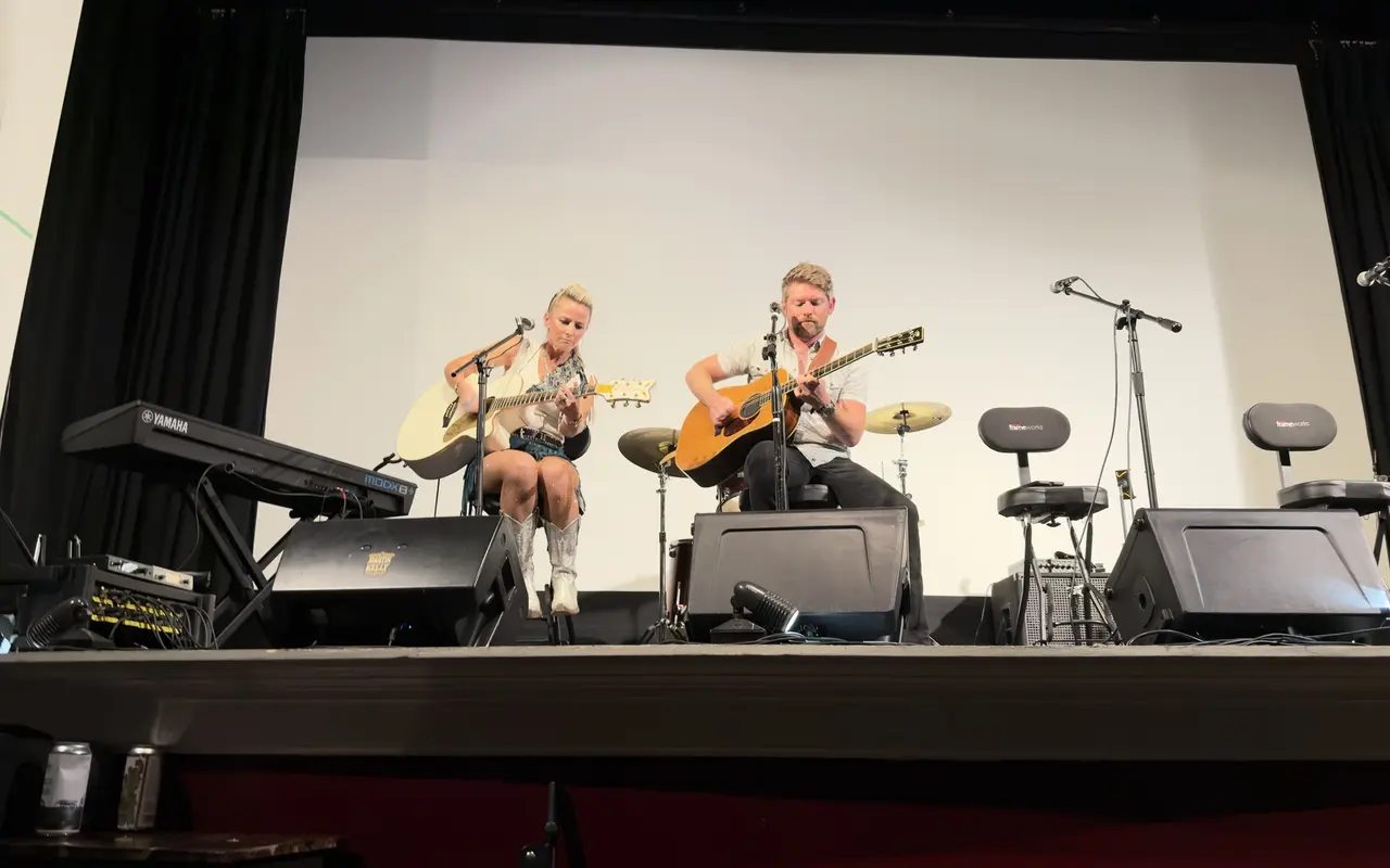 The full Strand Theatre stage in Oak Bluffs from the back rows: Martin and Kelly with acoustic guitars, a keyboard stage left and stage monitors along the front
