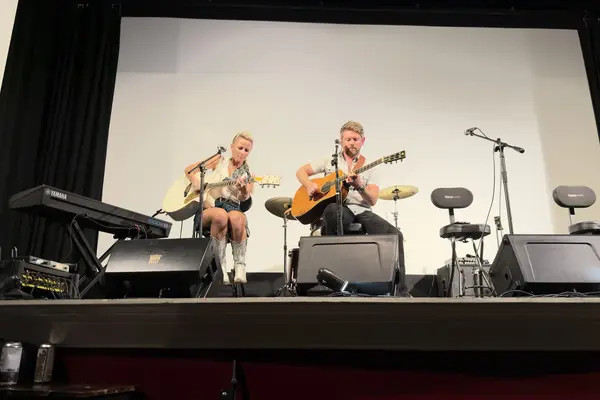 The whole stage from the back rows: the duo at center