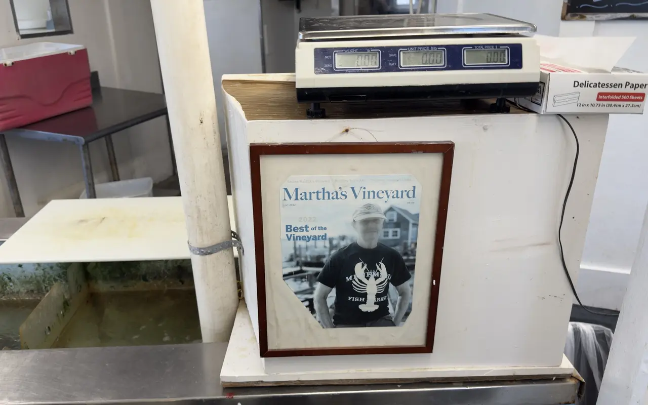 Framed Martha's Vineyard Magazine July 2022 Best of the Vineyard cover showing a man in a Menemsha Fish Market T-shirt, under a digital fish scale