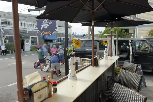 Midnight Taco: the outdoor counter, island taxi vans parked behind it
