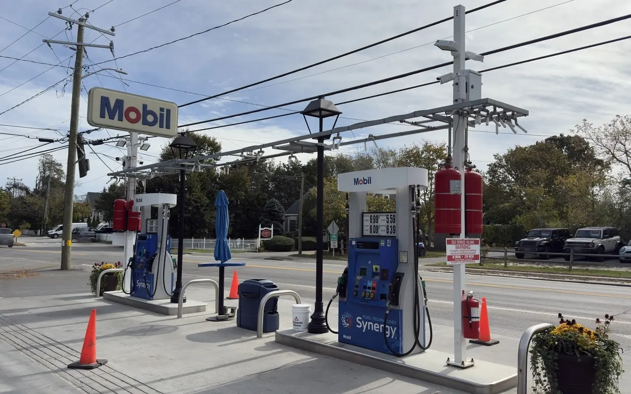 Mobil gas station in Edgartown in October 2026 with pump price board reading diesel 6.99, regular 5.59, extra 6.09 and supreme 6.39