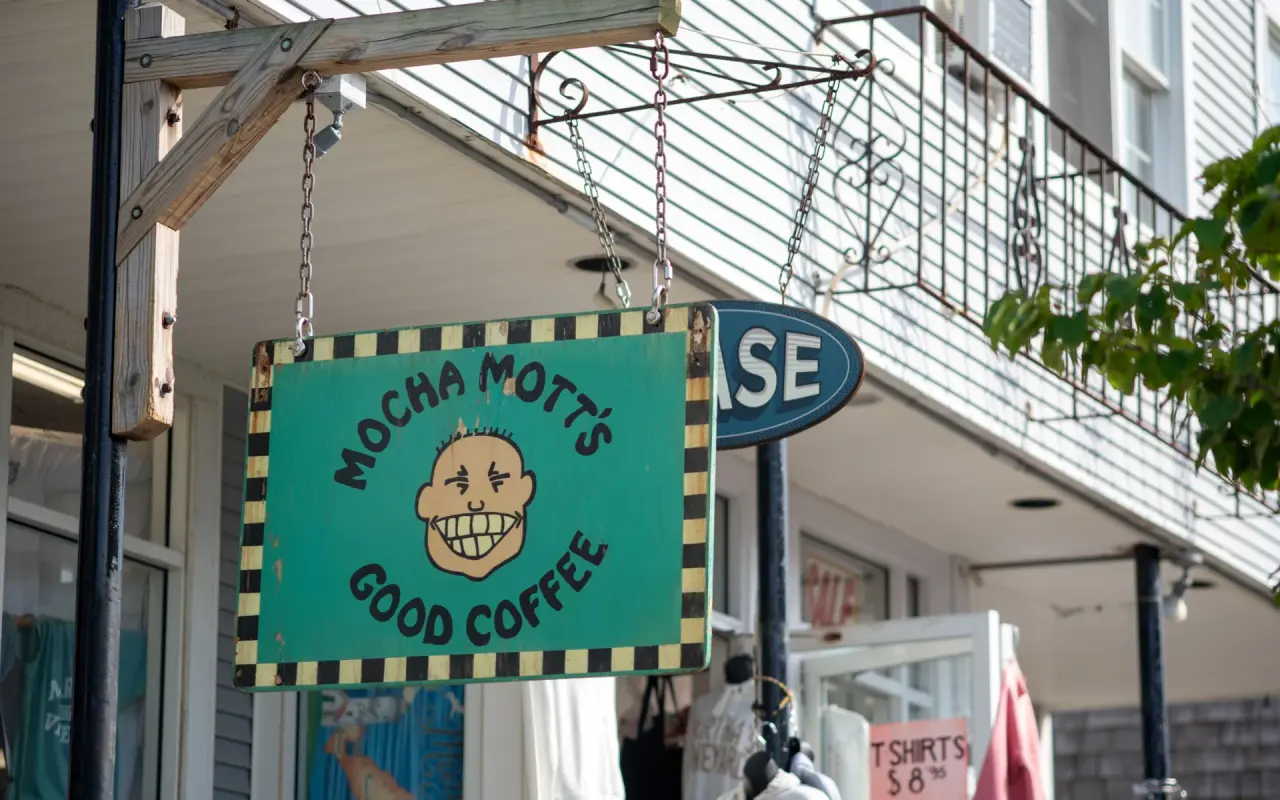 A hand-painted Mocha Mott's Good Coffee sign hanging outside a shop on Circuit Avenue in Oak Bluffs
