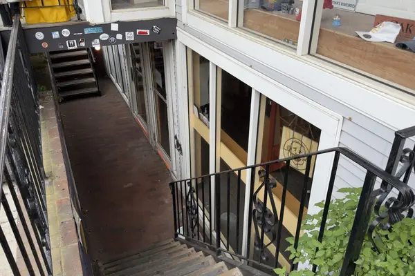 Down the stairs to Mocha Mott's, caps in the window above