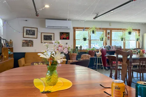 Inside the clubroom at Mo's Lunch: plants in the windows and a dining room like a friend's rec room.