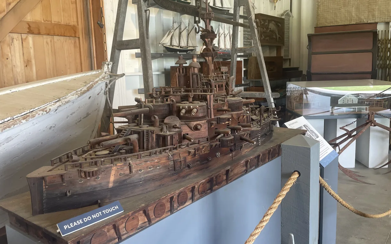 Wooden battleship model and whaleboat in the Martha's Vineyard Museum boat shed