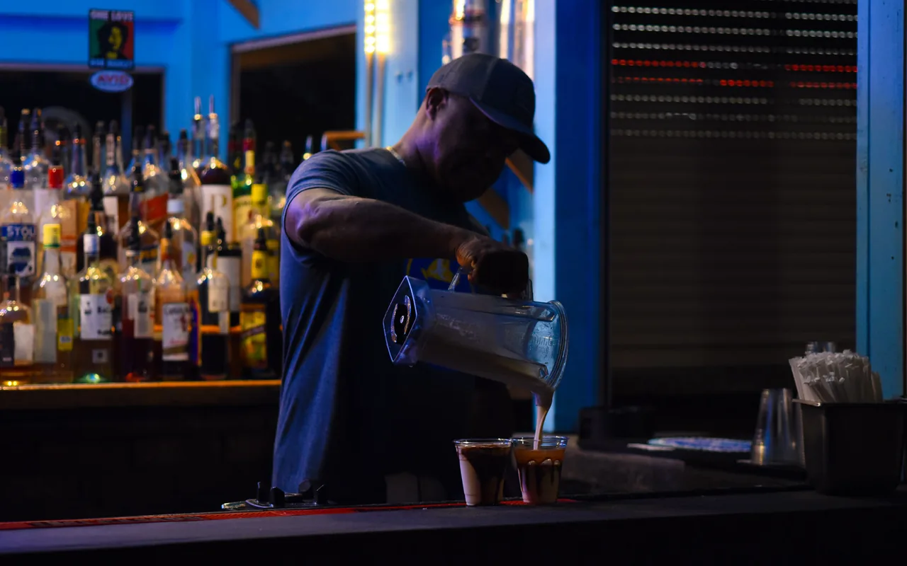 Bartender pouring frozen Dirty Banana cocktails at Donovan's Reef bar at Nancy's in Oak Bluffs