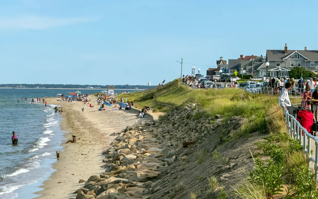Crowded Oak Bluffs town beach in August with Inkwell Beach in the distance