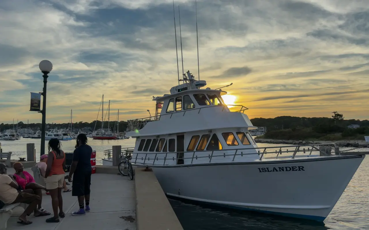 Boat named Islander docked in Oak Bluffs Harbor at sunset on Martha's Vineyard