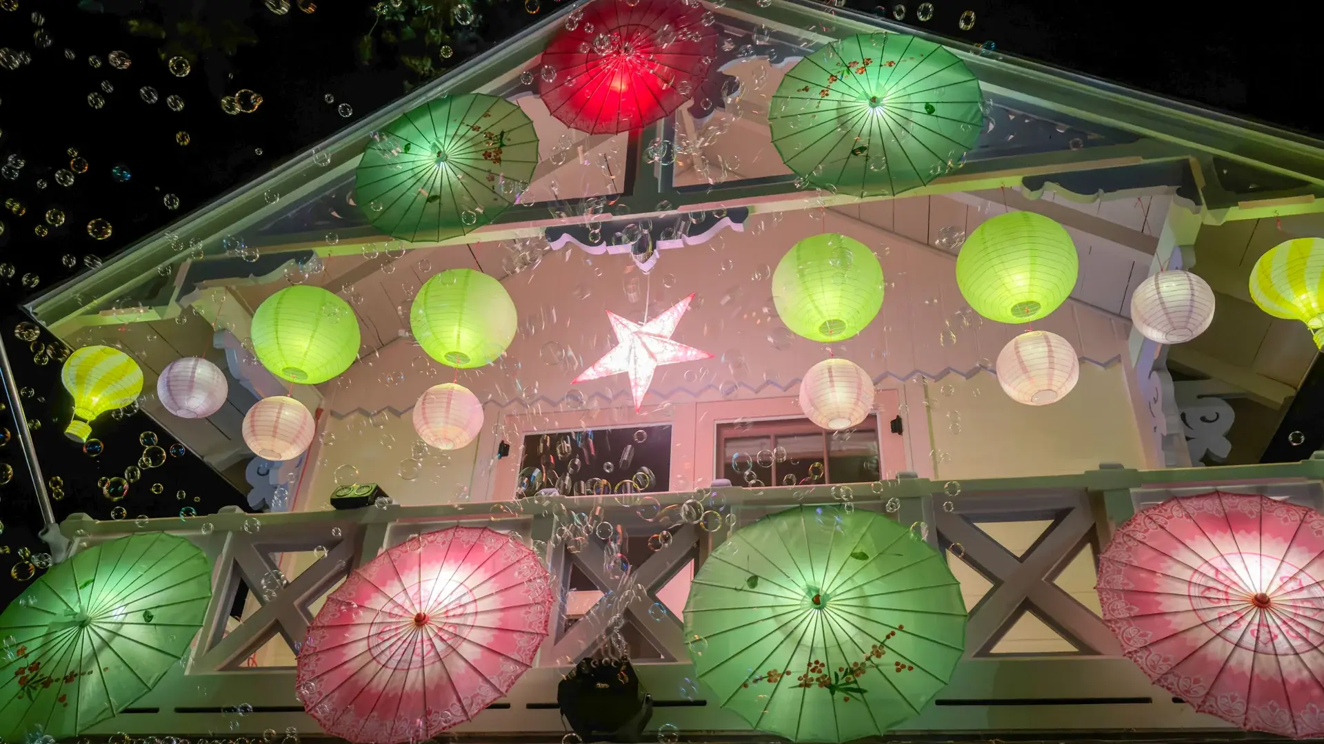 Paper umbrellas, lanterns and a bubble machine on one of the showpiece cottages