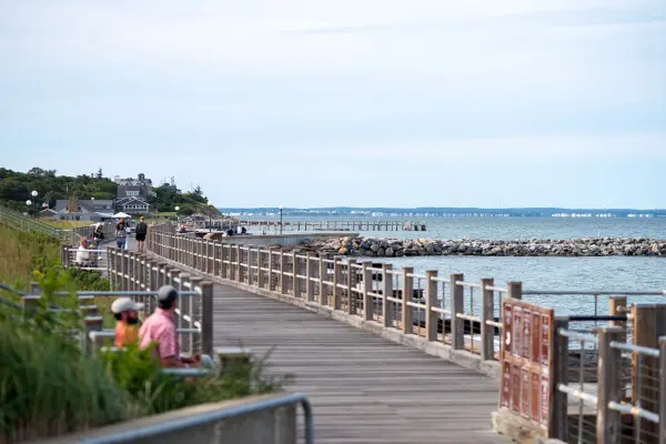 The harborside boardwalk at Oak Bluffs, benches along the rail