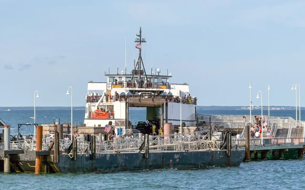 Steamship Authority ferry at the Oak Bluffs wharf with its bow open and passengers on the upper deck