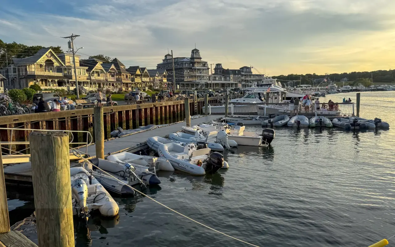 Boats moored in Oak Bluffs Harbor at sunset