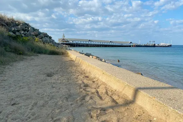 Shoreline below the jetty rocks with the ferry wharf beyond