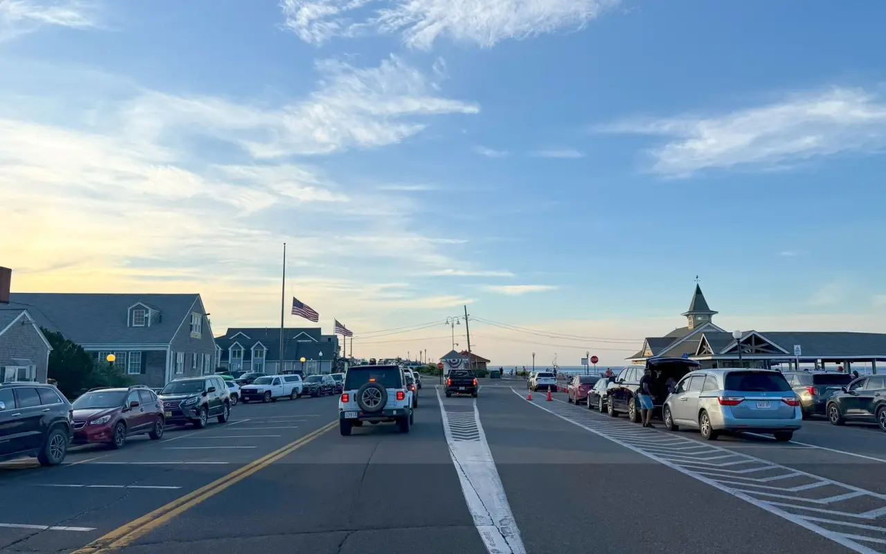 Cars parked along both sides of Seaview Avenue in Oak Bluffs on a summer evening