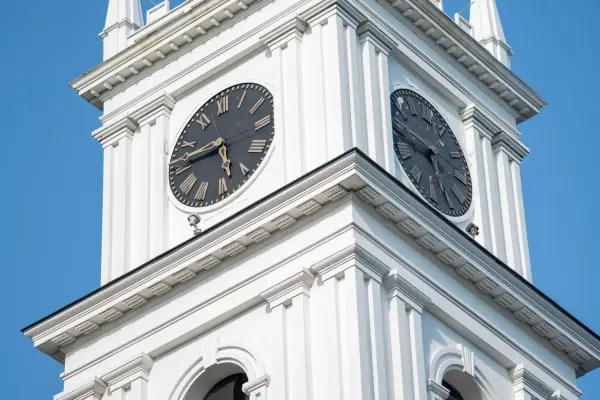 The clock tower and spires of the Old Whaling Church against a blue sky, Edgartown
