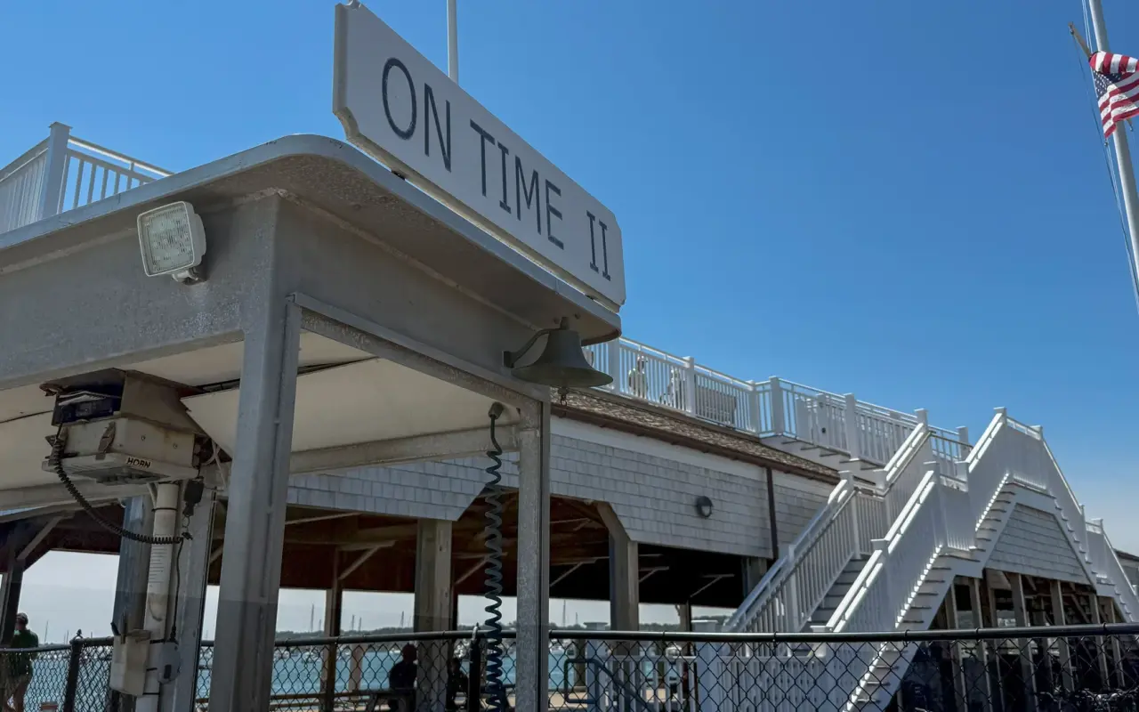 The small Chappaquiddick ferry On Time II at its Edgartown landing, name painted on the wheelhouse
