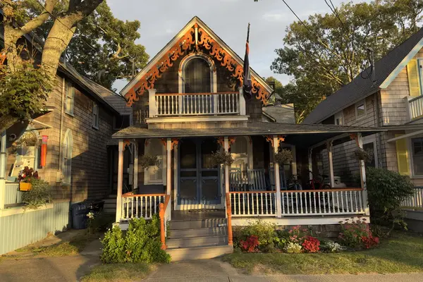Orange scrollwork on a gable, evening light