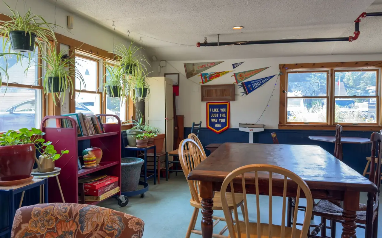 Dining room of the Portuguese-American Club in Oak Bluffs with pennants and a wooden table