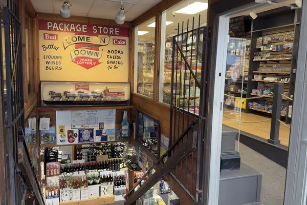 Down the stairs to a basement package store in Oak Bluffs, gift shop beside it