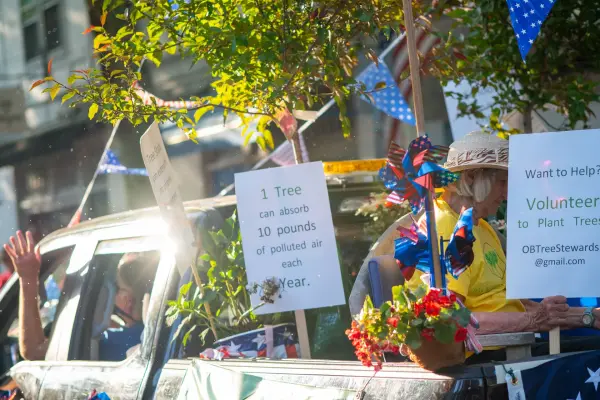 The Oak Bluffs Tree Stewards with "one tree absorbs 10 pounds of polluted air" signs in the Edgartown parade