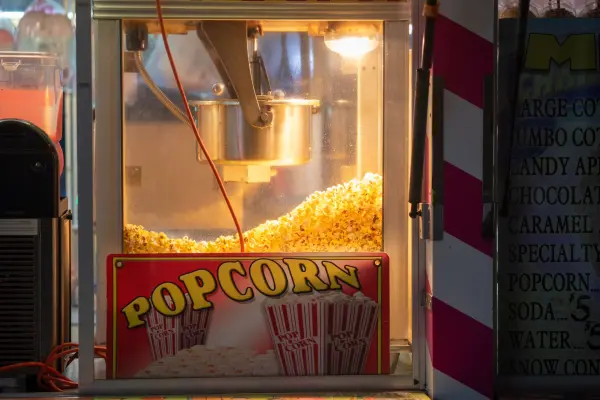 Fresh popcorn piling up behind the glass at the concession stand
