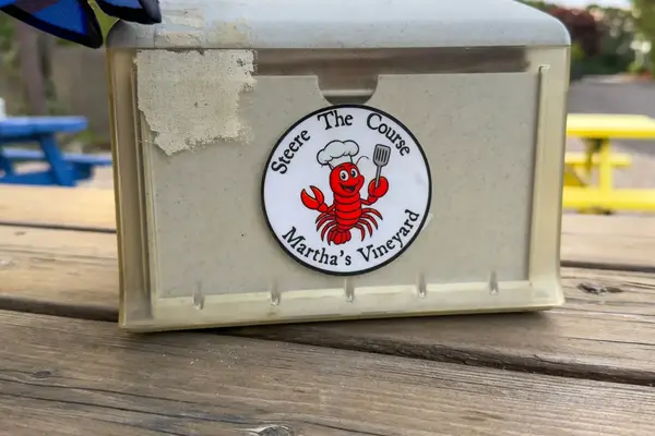 Napkin holder sticker on a picnic table at Putt Up and Eat in Vineyard Haven