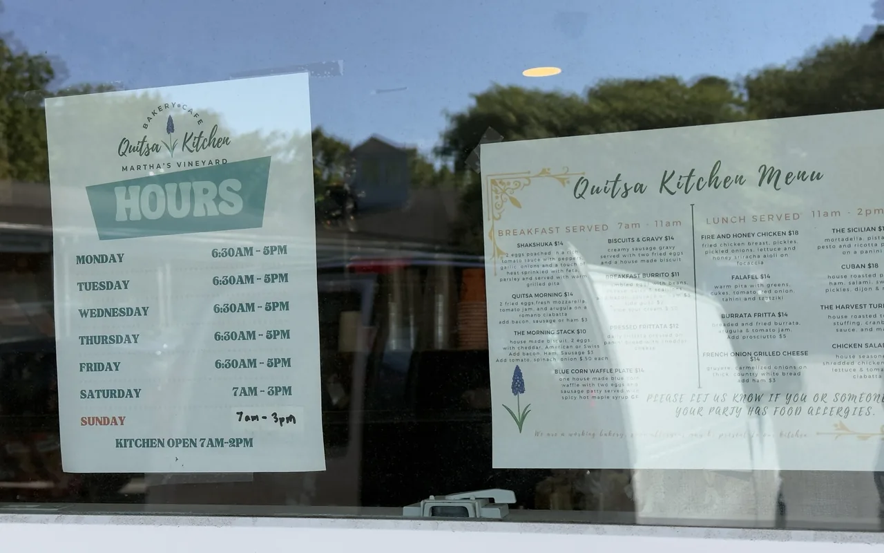 Hours and menu sheets posted in the window of Quitsa Kitchen in Vineyard Haven