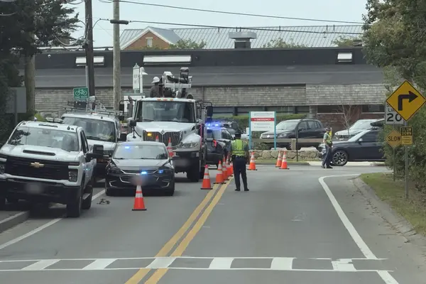Beach Road at the hospital: a utility crew and police detail, September 2026