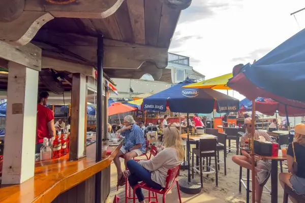 Sand Bar and Grille patio on Oak Bluffs harbor, umbrellas and a full crowd