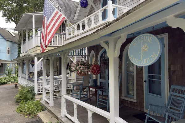 The Seaside Sanitarium sign on a blue-trimmed porch in the Campground