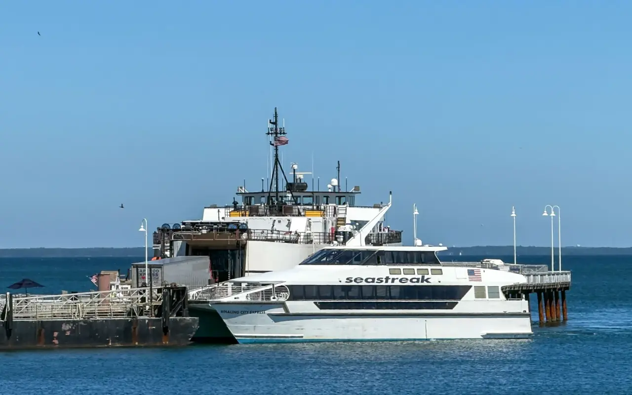 Seastreak fast ferry catamaran docked at the Oak Bluffs pier with the Steamship Authority ferry behind