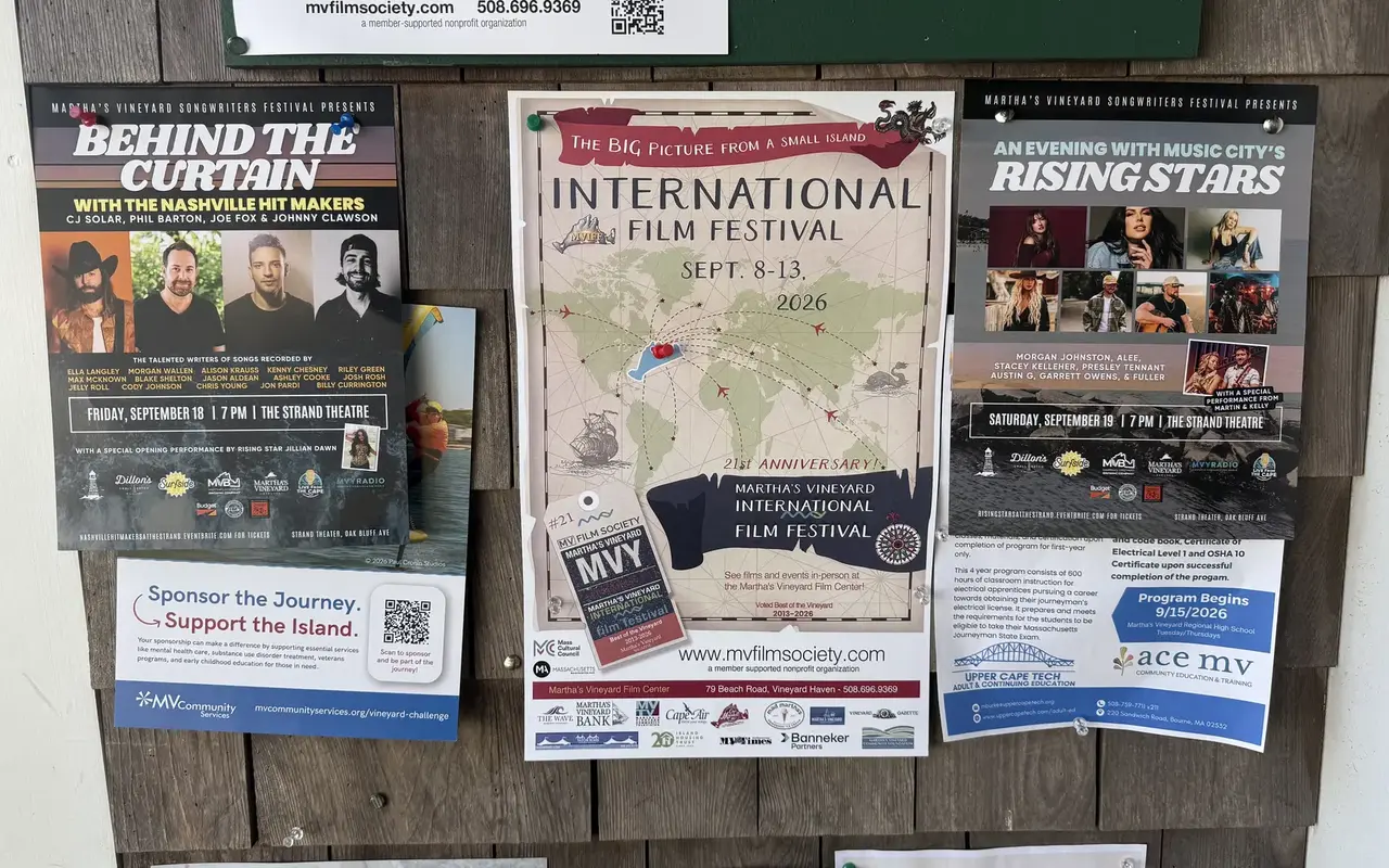 Posters for the Martha’s Vineyard International Film Festival and two Strand Theatre concerts pinned to a shingled community board