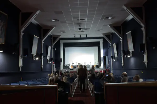 The Strand auditorium filling up before a show: blue seats, the film posters still on the walls