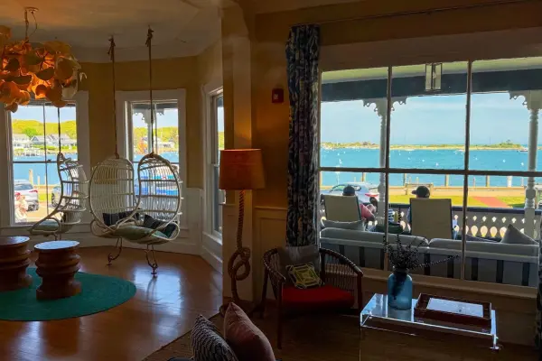 Hanging rattan chairs and harbor views inside the Summercamp hotel