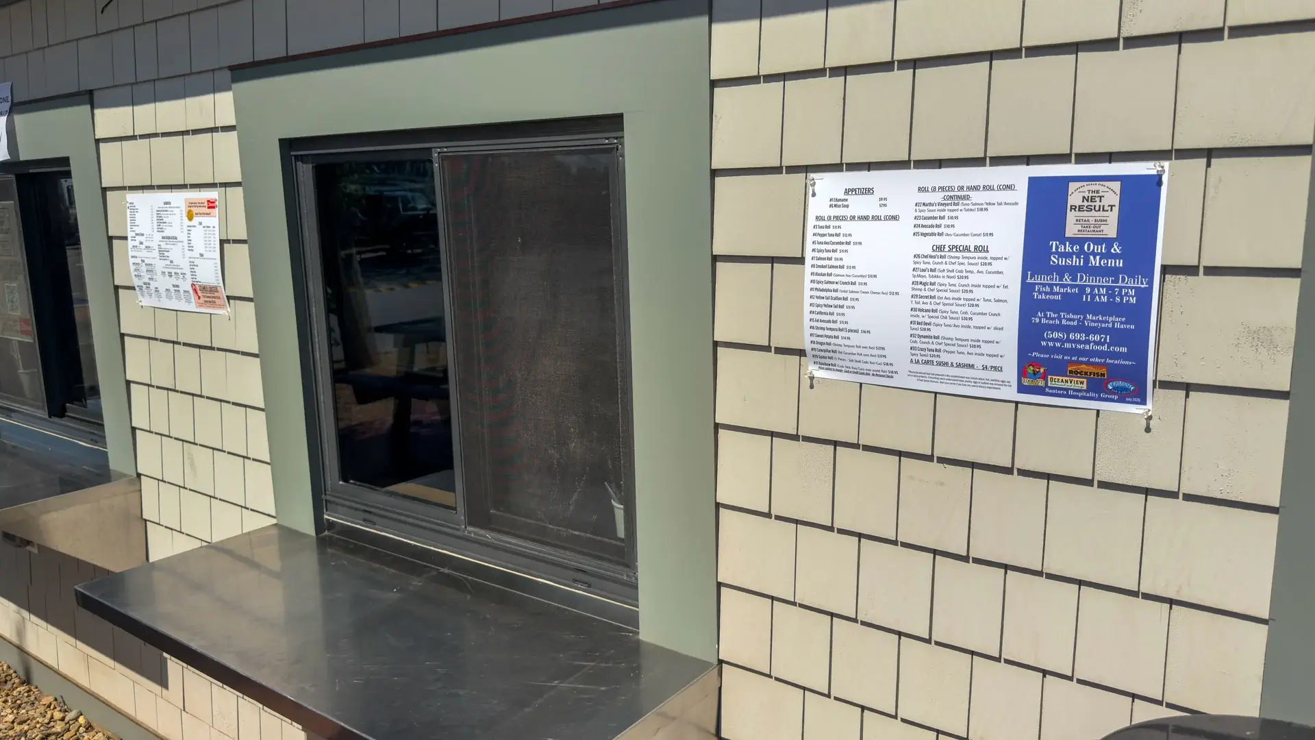 Takeout window at The Net Result with the sushi and seafood menus posted