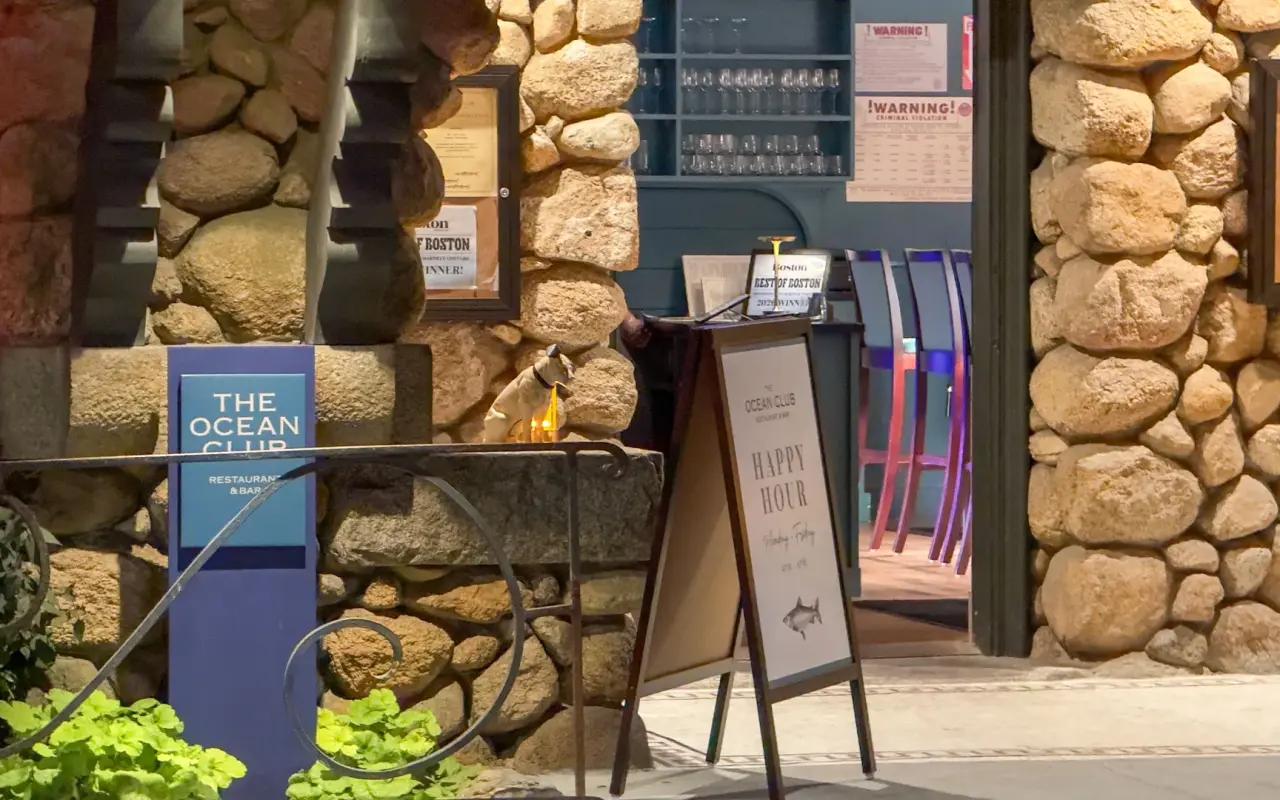 Happy hour sign at the stone entrance of The Ocean Club restaurant in Vineyard Haven