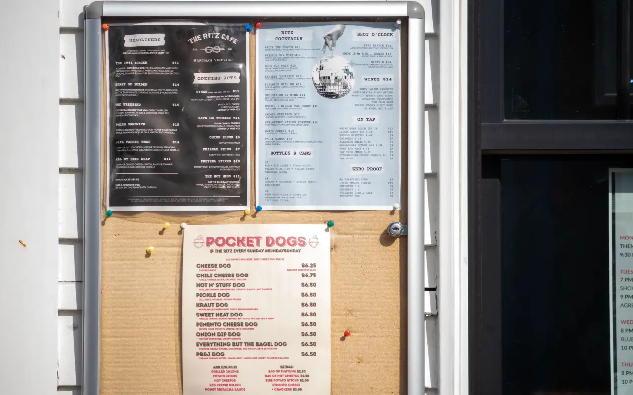 The food menu board posted outside the Ritz Café in Oak Bluffs with hot dogs and bar snacks listed