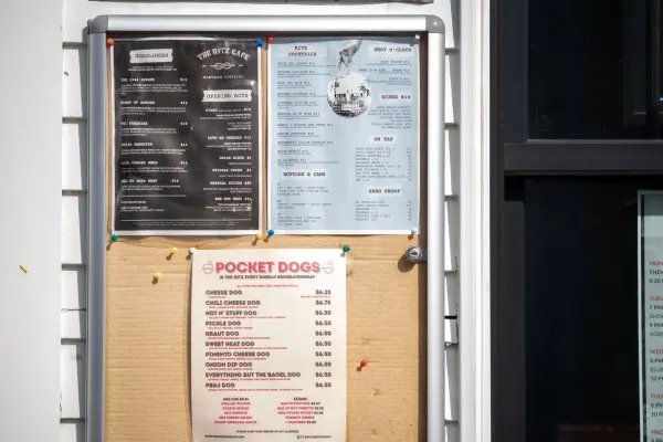 The Ritz posts its menus in the window: headliners, cocktails and the Pocket Dogs board.