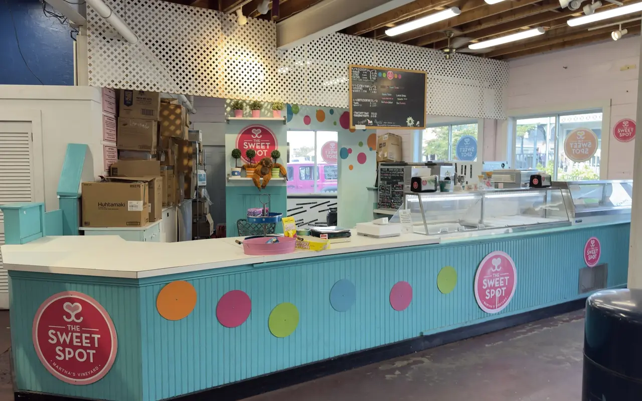 Turquoise ice cream counter with colorful dots and The Sweet Spot logo inside a shop in Oak Bluffs