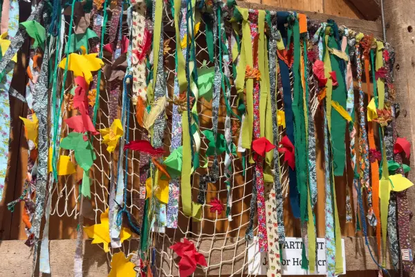 Strips of printed fabric woven through fishing net, an Island twist on fair crafts
